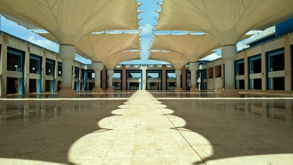 The candlelit Riverside Pavilion at dusk, with the glass wall open to the river.